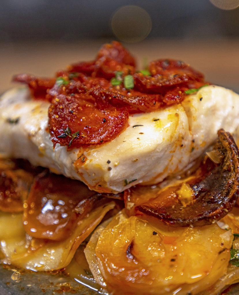 Chorizo Crusted Hake on Boulangère Potatoes - Ainsley Harriott